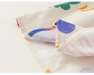 Detail view of cotton summer dress hem with colorful pattern and professional stitching