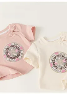 Detail of traditional Chinese frog buttons and embroidery on soft ribbed cotton t-shirt