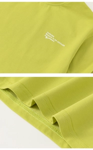 Detail of lime green cotton t-shirt with screen print and double-needle hem stitching