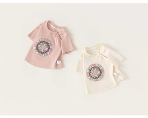 Detail of traditional Chinese frog buttons and embroidery on cotton baby t-shirts