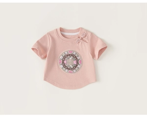 Detail of pink cotton baby t-shirt featuring traditional Chinese buttons and floral embroidery