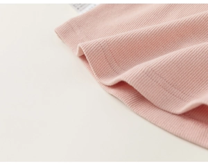 Detail of pink ribbed knit fabric with double-needle stitching on children's Chinese tee