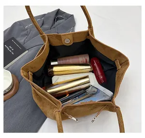 Top view of large brown suede tote bag showing spacious interior with magnetic closure