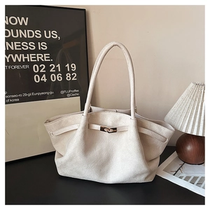 Detail of oat suede tote bag showing soft texture and elegant golden metal clasp