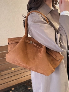 Minimalist caramel suede tote bag with metal buckle closure and long shoulder handles