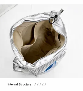 Interior view of spacious silver tote bag showing main zipper pocket and side slip pocket