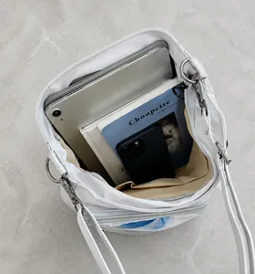 Interior view showing the large capacity and clear front pocket of the white tote bag