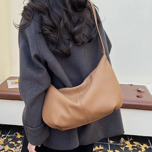 Macro detail of caramel hobo bag featuring premium pebble leather texture and stitching