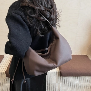 Detailed view of the dark brown hobo crossbody bag with adjustable knot shoulder strap