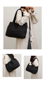 Detail of black quilted puffer tote bag with rope handles and soft plush pendant