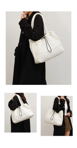 Close-up of white quilted puffer tote bag featuring durable nylon fabric and drawstring detail
