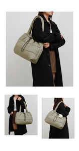 Detail of green quilted down tote bag with drawstring texture and large capacity