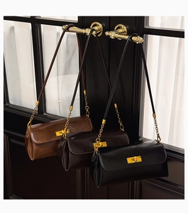 Three leather shoulder bags in brown, coffee, and black with golden twist-lock details