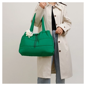 Quilted grass green puffer tote bag with plush bear charm and drawstring detail