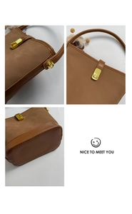 Détails du sac seau marron en daim avec fermoir doré et accessoire de charme en peluche