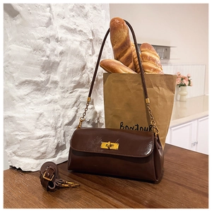Brown vintage shoulder bag detail with gold clasp and detachable adjustable strap