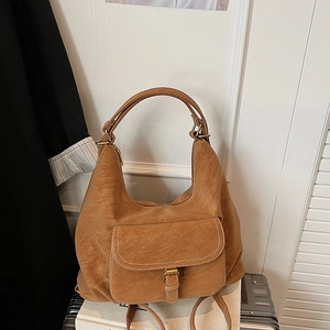 Detail view of caramel hobo bag with litchi grain PU leather and contrast stitching