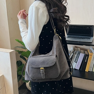 Detail view of retro gray suede tote bag with white stitching and front pocket