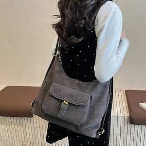 Detail view of charcoal grey hobo bag with front pocket and contrast stitching decoration