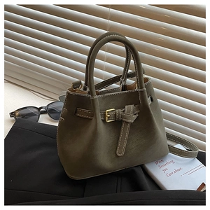 Detail view of vintage olive bucket bag with white contrast stitching and metal buckle