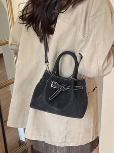 Vintage black faux suede bucket bag with contrast stitching and shoulder strap