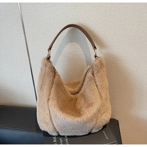 Detail of khaki faux fur hobo bag with brown leather handle and gold metal ring