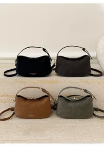 Selection of crescent leather handbags in black, brown, caramel, and green with gold accents