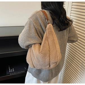 Detail shot of khaki faux fur shoulder bag with soft plush texture and leather strap