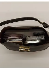 Top macro view of dark brown leather bucket bag showing inner capacity for daily essentials