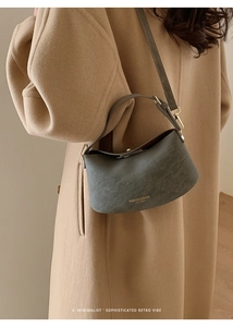 Close-up of retro dark green leather handbag with gold lettering and metallic hardware
