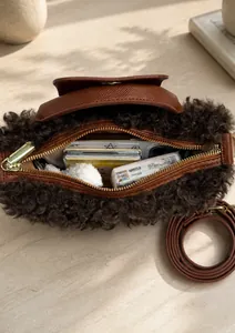 Top view of brown plush dumpling bag showing spacious interior for phone and accessories