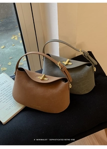 Detailed view of matte leather bucket bags with gold rotating buckles and gold branding