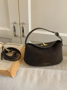 Minimalist dark brown suede bucket bag with gold clasp and detachable shoulder strap