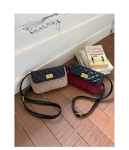 Detail showing beige and burgundy crossbody bags with quilted black leather flaps and gold locks