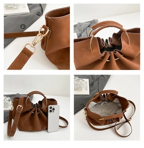 Detailsicht der braunen PU-Beuteltasche mit rundem Metallgriff und internem Stauraum