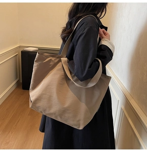 Detalle del bolso tote de lona color café con modelo para referencia de tamaño y caída real