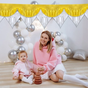 Gold and silver foil fringe banner for birthday party wall decoration with warm lighting