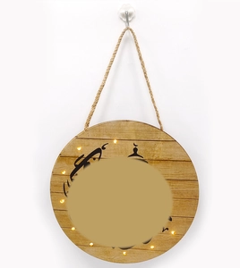 Detail of wooden Ramadan moon hanging sign with LED lights and mosque silhouette decor
