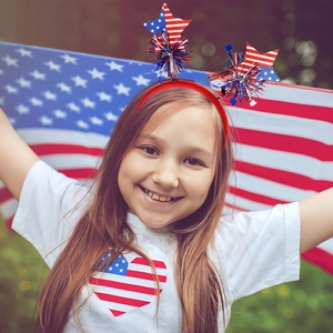 Girl wearing USA Independence Day headband with glitter stars and metallic tassels