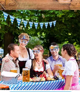Close-up of Oktoberfest party glasses and blue white checkered flags for event decoration