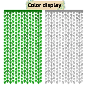 Detail view comparing green and silver monstera leaf fringe curtains for forest party decor