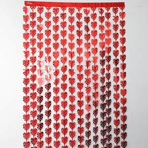 Macro shot of metallic red heart-shaped leaf fringe curtain for party wall decoration