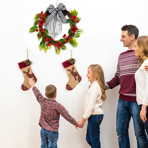 Christmas wreath with red berries and reindeer stockings for festive holiday home wall decor