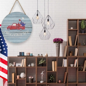 Rustic wood Independence Day hanging sign with vintage red truck and star decorations