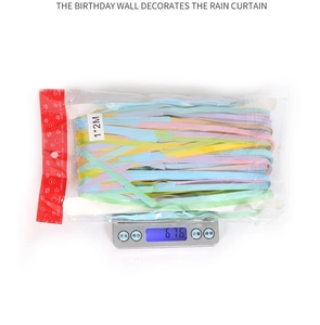 Weight measurement of macaron foil fringe curtain on a digital scale for party decor