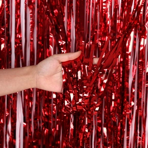 Detail of red metallic foil tinsel curtain for party background showing fringe texture