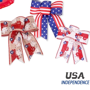 Close-up of USA Independence Day bow set with star patterns and red trucks on ribbons