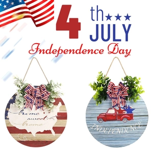 Close-up of July 4th wooden door signs featuring American flags and home sweet home text