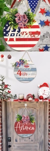 Detail of 4th of July patriotic round wooden signs with burlap bows and greenery