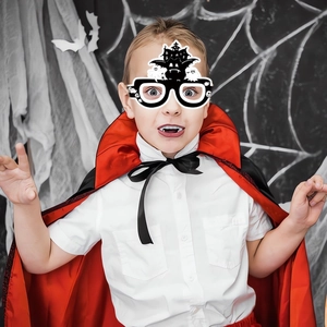Kid vampire costume set featuring a black red cloak and spooky Halloween paper glasses